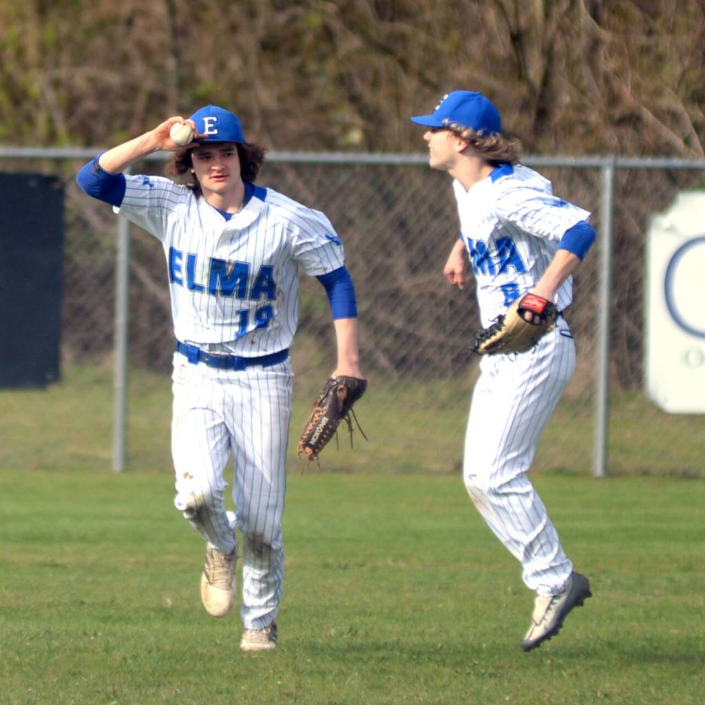 RYAN SPARKS | THE DAILY WORLD Elma left fielder Eastin Wright (18) is met by center fielder TJ Dunlap after making a diving catch during an 11-5 loss to Montesano on Monday in Elma.