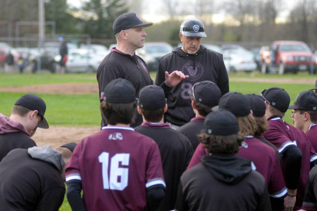 RYAN SPARKS | THE DAILY WORLD Montesanos Mike Osgood, left, talks to his team after collecting his 100th win as a head coach with an 11-5 win over Elma.