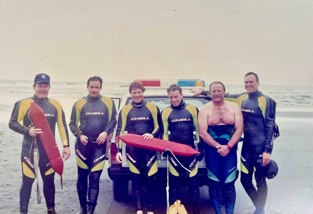 Members of the Ocean Shores surf rescue team, including Jim Davis, second from left, pose for a photo. Photo: The Davis Family