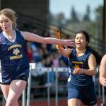 PHOTO BY FOREST WORGUM Aberdeens Mylee Tran, second from right, hands the baton to Alyssa Caskey during the girls 4x200-meter relay on Wednesday in Aberdeen.