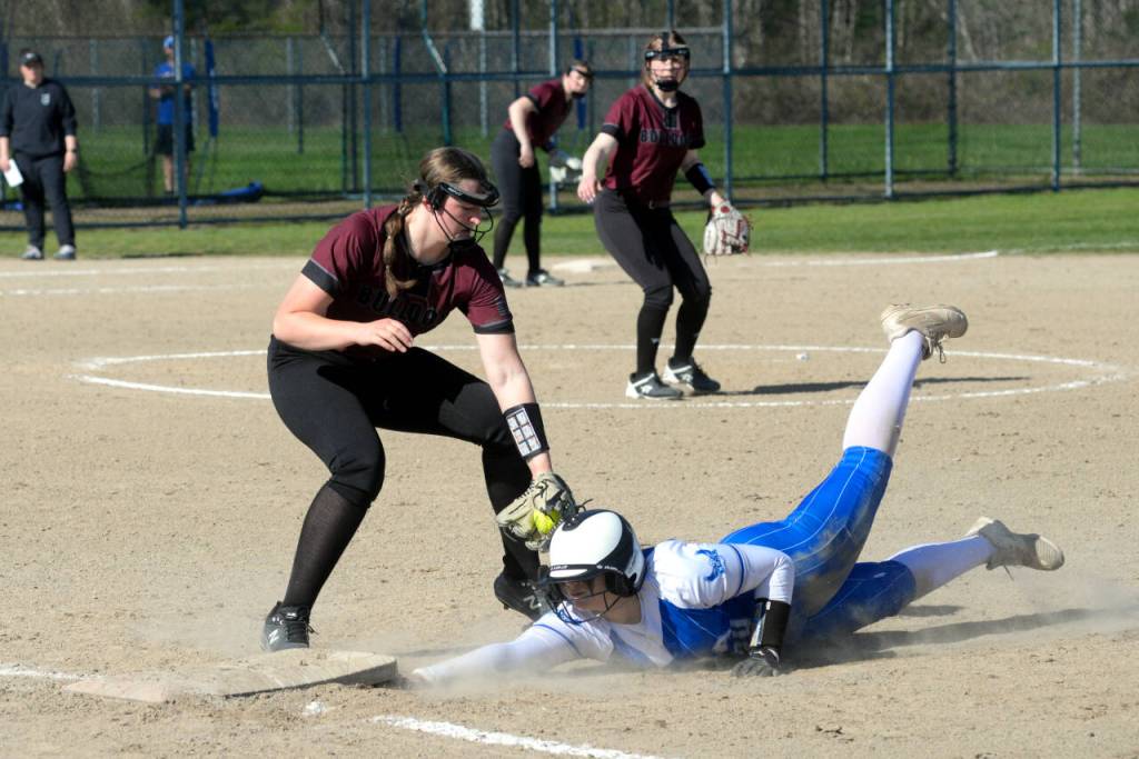 RYAN SPARKS | THE DAILY WORLD Elmas Callie Galligan dives back safely to first as Montesanos Kylee Wisdom applies a tag during the Bulldogs 12-6 victory on Thursday in Elma.