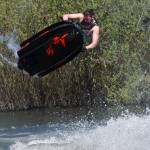 Freestyle jet-skier Tanner Thomas performs an aerial trick on Vance Creek Pond on Saturday, April 29, during the halftime show of the PNW Water X racing event.