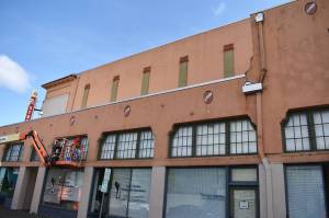 Matthew N. Wells / The Daily World
Corey Wright, on the lift, is part of a small team painting for EverGreene Architectural Arts to help restore the 7th Street Theatre. In addition to other projects that have been ongoing at the theater, and ones that will follow this Phase two, the theater is undergoing new exterior paint and resealing of cracks.