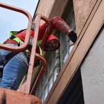 Matthew N. Wells / The Daily World
Corey Wright, of EverGreene Architectural Arts, paints trim along the J Street side of the 95-year-old 7th Street Theatre, in Hoquiam. The theater is undergoing a repainting, sealing of cracks on the exterior and other work.