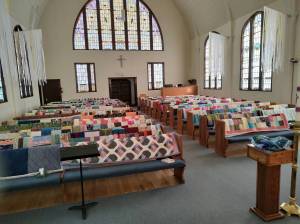 Doris Tieder
On Sunday, Amazing Grace Lutheran Church was decorated with more than 170 quilts, assembled by a group of women who gather twice a month for fellowship and sewing. Twice a year, the quilts are shipped to Lutheran World Relief, an organization that distributes them throughout the world, most recently to Ukraine, Turkey and Syria. Locally quilts were sent to the Friendship House and Family Promise.