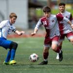 PHOTO BY FOREST WORGUM Montesanos Felix Romero (14) presses forward against La Centers Reynolds Cottle during the Bulldogs 7-2 victory in the 1A District 4 Tournament on Saturday in Montesano.