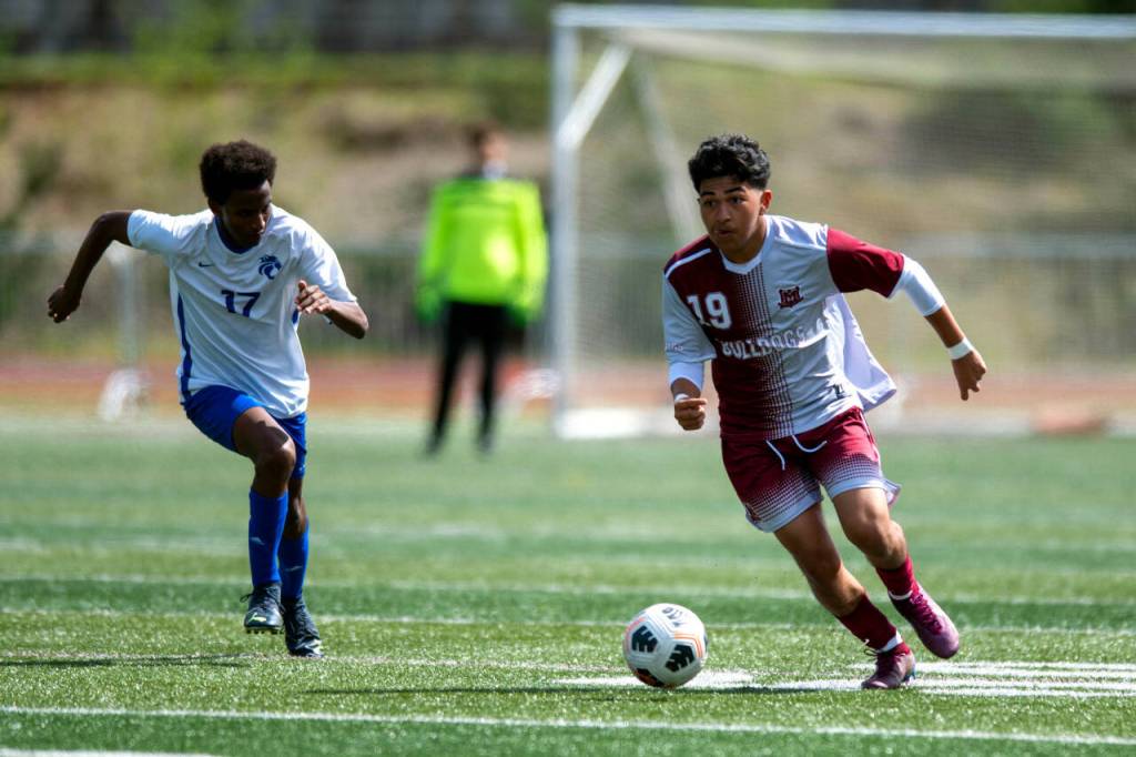 PHOTO BY FOREST WORGUM Montesanos Cristofer Tobar (19) pulls away from La Centers Roman Ferguson during the Bulldogs 7-2 victory in the 1A District 4 Tournament on Saturday in Montesano.