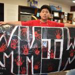 Matthew N. Wells / The Daily World
Anthony Watkins, a senior at Hoquiam High School, holds the eight-foot-long banner he made for the Hoquiam students Missing and Murdered Indigenous Women walk, which took place on Friday. Watkins, a member of the Confederated Tribes of the Umatilla Indian Reservation, was proud of the work he did with the banner. The banner took a week to make. I think its great how younger generations can get the community together and speak of the change that it needs, Watkins said.