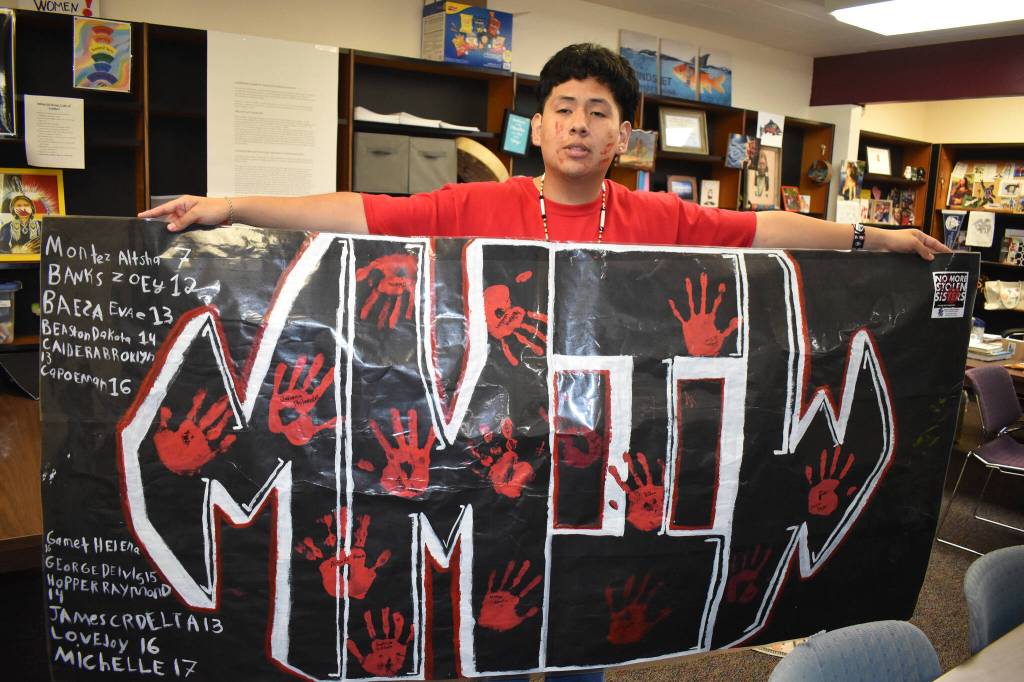 Matthew N. Wells / The Daily World
Anthony Watkins, a senior at Hoquiam High School, holds the eight-foot-long banner he made for the Hoquiam students Missing and Murdered Indigenous Women walk, which took place on Friday. Watkins, a member of the Confederated Tribes of the Umatilla Indian Reservation, was proud of the work he did with the banner. The banner took a week to make. I think its great how younger generations can get the community together and speak of the change that it needs, Watkins said.