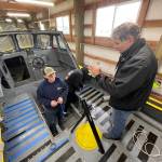 Paul Mirante, instructor for Ocosta High Schools maritime program, directs Logan Johnson as he paints an old Coast Guard lifeboat that students are restoring for display. (Michael S. Lockett / The Daily World)