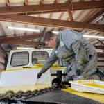 Evan Brockhoff, a student in Ocosta High Schools maritime program, paints an old Coast Guard lifeboaty. (Michael S. Lockett / The Daily World)