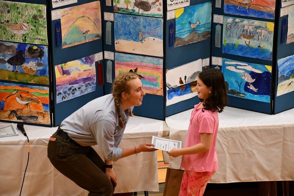Courtesy photo/ U.S. Fish and Wildlife Service
Lacey Wright, Americorps member and environmental education coordinator for the Grays Harbor National Wildlife Refuge, presents the first place for the second grade category to Lilly Blake for her drawing of a Pacific golden plover during the award ceremony at Hoquiam Middle School on May 7.