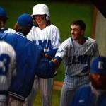 RYAN SPARKS / THE DAILY WORLD 
Elma catcher Ethan Camus (22) is congratulated by teammates after scoring a run in the seventh inning of a 4-2 loss to Montesano in a 1A District 4 playoff game on Tuesday in Hoquiam.