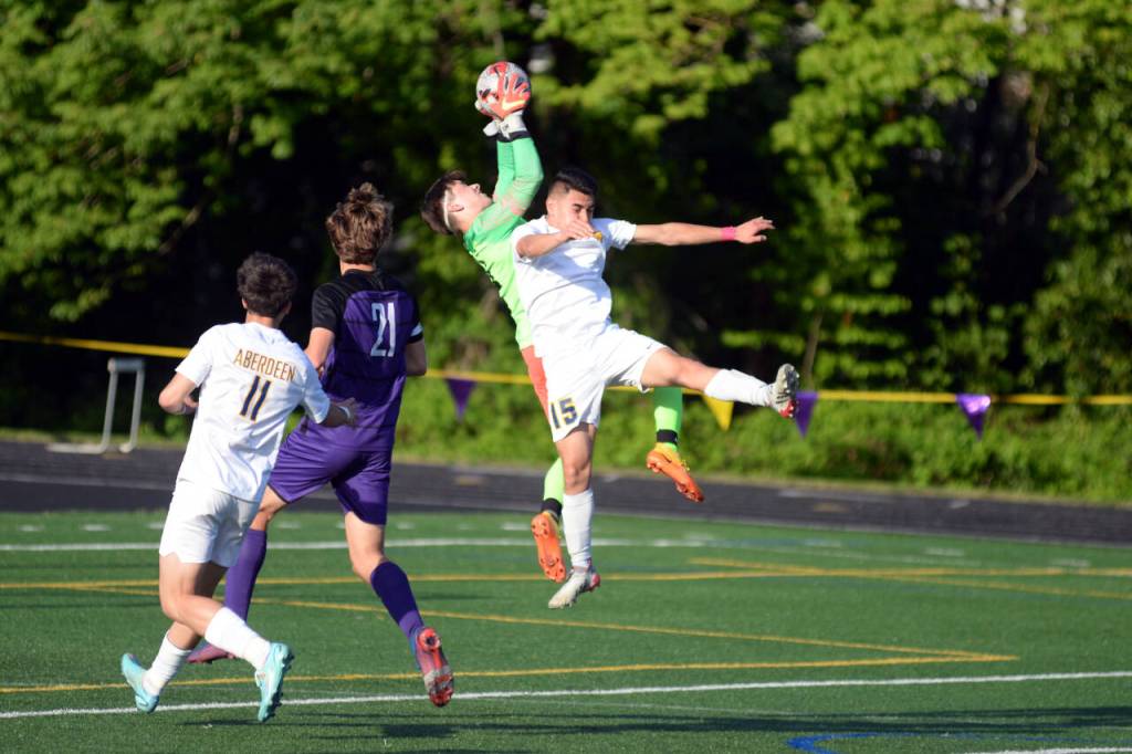 RYAN SPARKS | THE DAILY WORLD Aberdeens Carlos Hernandez leaps in an attempt to head the ball against Columbia River goal keeper Cameron Harris during the Bobcats 3-0 loss in the 2A District 4 championship game on Thursday at Columbia River High School in Vancouver.