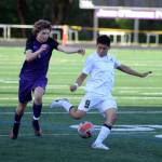 RYAN SPARKS | THE DAILY WORLD Aberdeens Gilberto Lopez (9) boots the ball forward against Columbia Rivers Evan Roscoe during the Bobcats 3-0 loss in the 2A District 4 championship game on Thursday at Columbia River High School in Vancouver.