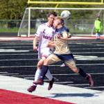 RYAN SPARKS | THE DAILY WORLD Montesano junior midfielder Luke Clements (2) heads the ball against Seton Catholics Eli Wall during the Bulldogs 2-1 victory (4-2 on penalty kicks) in the 1A District 4 Championship game on Saturday in Tenino.