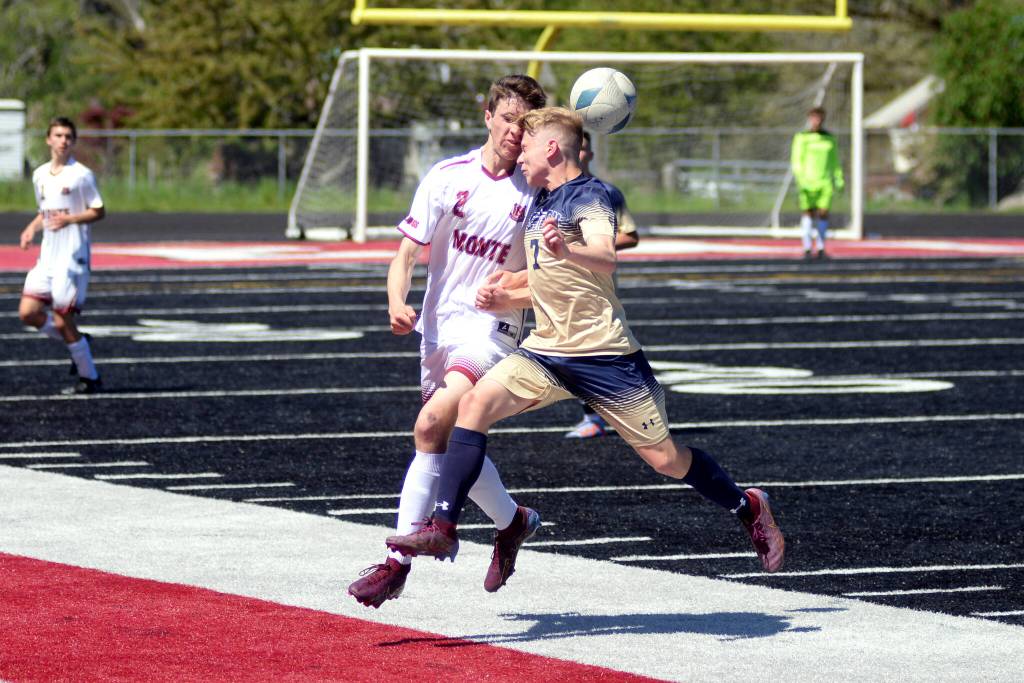 RYAN SPARKS | THE DAILY WORLD Montesano junior midfielder Luke Clements (2) heads the ball against Seton Catholics Eli Wall during the Bulldogs 2-1 victory (4-2 on penalty kicks) in the 1A District 4 Championship game on Saturday in Tenino.