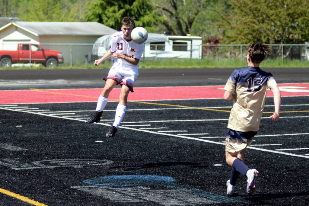RYAN SPARKS | THE DAILY WORLD Montesano senior defender Michael Neal heads the ball forward during a 2-1 victory over Seton Catholic in the 1A District 4 Championship game on Saturday at Tenino High School.