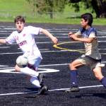 RYAN SPARKS | THE DAILY WORLD Montesano sophomore forward Felix Romero (14) drives forward against Seton Catholics Zeek Valencia-Mendez during the Bulldogs 2-1 victory in the 1A District 4 Championship game on Saturday in Tenino.