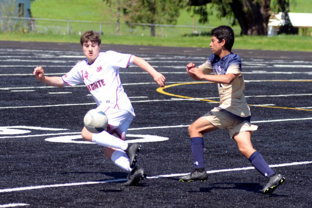 RYAN SPARKS | THE DAILY WORLD Montesano sophomore forward Felix Romero (14) drives forward against Seton Catholics Zeek Valencia-Mendez during the Bulldogs 2-1 victory in the 1A District 4 Championship game on Saturday in Tenino.
