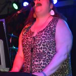 Tiffany Maki, singer and keyboardist for Ms. Maki & Co., belts out a lyric during her band's performance Saturday evening at Celebrate Summer Jam at Ocean Shores Convention Center. Maki made sure the crowd, and her bandmates, know how appreciative she is of the stellar work they did on stage. (Matthew N. Wells / The Daily World)