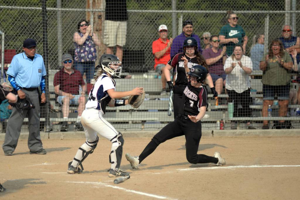 RYAN SPARKS / THE DAILY WORLD Ocostas Jolissa Schlegel scores a run while Pe Ell-Willapa Valley catcher Payton Peterson defends during the Wildcats 2-0 win in the 2B District 4 semifinals on Wednesday in Centralia.