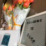 Upon entering The Tap Room, raffle prizes were on a nearby table, along with a Grays Harbor Young Professionals (GHYP) welcome sign and tulips, which were for Desiree Lindgren, GHYPs founder, and Sydney Renae, who helped her start it. (Matthew N. Wells / The Daily World)