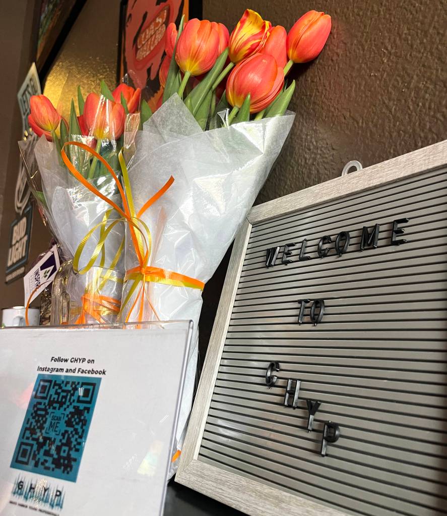 Upon entering The Tap Room, raffle prizes were on a nearby table, along with a Grays Harbor Young Professionals (GHYP) welcome sign and tulips, which were for Desiree Lindgren, GHYPs founder, and Sydney Renae, who helped her start it. (Matthew N. Wells / The Daily World)