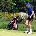 SUBMITTED PHOTO Elma freshman Olivia Moore lines up a put at the district-championship meet at the Tumwater Valley Golf Course earlier this week. Moore shot a two-day total of 155 to win the individual championship.
