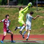 PHOTO BY FOREST WORGUM Montesano goal keeper Jayden McElravy snatches the ball out of the air against Seton Catholics Teagan Petracca (9) as Montes Spencer Lovell looks on during the Bulldogs 2-0 loss in the 1A State Tournament quarterfinals on Saturday in Montesano.