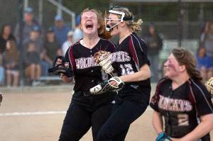 Ocosta's Jessie Gilbert yells in celebration after helping the Wildcats win the 2B District 4 championship over Adna May 20 at Borst Park in Centralia.