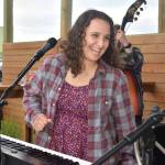 Matthew N. Wells / The Daily World
Amanda Ransom, who sings and plays the keyboard with her Saturday night bandmates on May 20, smiles during a lively and fun performance at Mount Olympus Brewing. Ransom said playing the piano is in her blood.