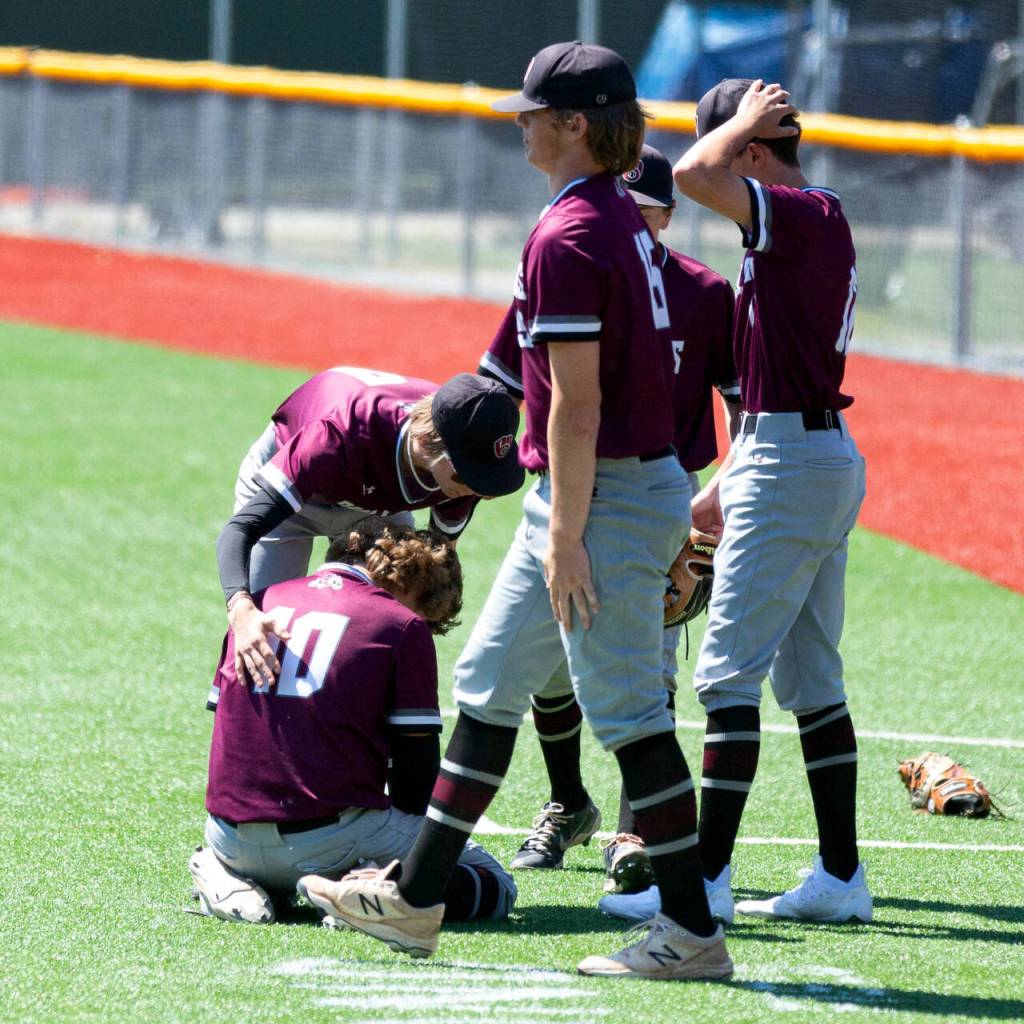 ALEC DIETZ | THE CHRONICLE Montesano players console pitcher Skylar Bove after a walk-off balk led to the winning run in a 5-4 loss to Naches Valley in the 1A State semifinals at Joe Martin Stadium in Bellingham on Friday.