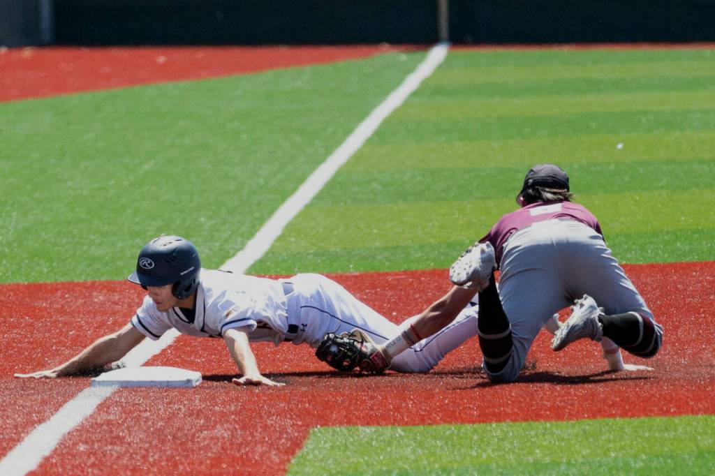 ALEC DIETZ | THE CHRONICLE Montesano third baseman Jaxson Wilson tags out Naches Valleys Thane Denny in the 1A State Tournament semifinals at Joe Martin Stadium in Bellingham on Friday.