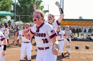 PHOTO BY SHAWN DONNELLY Montesanos Kylee Wisdom (18), Carsyn Wintrip (left) and Allison Mills (background) celebrate winning the 1A State Softball Championship after an 8-2 victory over Royal on Sunday in Richland.
