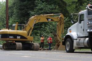 Michael S. Lockett / The Daily World
Workers repair damage after a driver was involved in a fatal single-vehicle accident early Tuesday morning on Ocean Beach Road near Hoquiam.