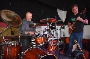 Matthew N. Wells / The Daily World
Larry Cowles, drummer for 80s cover band This Way Out, left, hammers the drums as Justin Kautzman, guitarist and singer for Black Shepherd, plays Cowles electric guitar Tuesday afternoon inside The Loading Dock, in downtown Aberdeen.