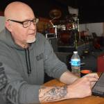 Matthew N. Wells / The Daily World
Larry Cowles, who rents The Loading Dock  202 E. Wishkah St., shows how easy it is to stay plugged in to what the venue hosts each month. Just text GHMUSIC to 855-642-7684 to stay informed. Cowles said after texting the number to opt in to the venue updates, people receive reminders so they never lose track of when the next live show happens. Admission to the shows is $10 and outside the money that goes to rent the venue, everything else goes to the bands that play there.