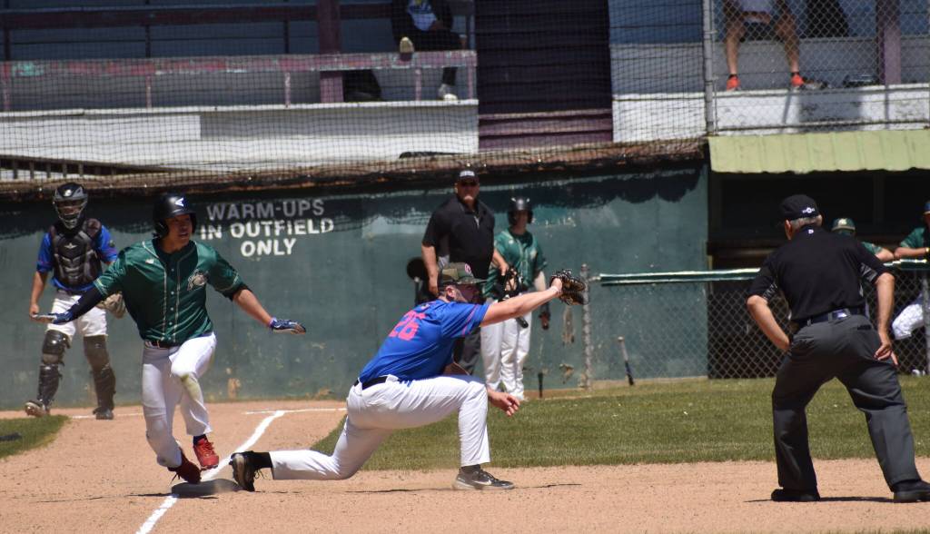 A close play at first base results in an out recorded by the Chinooks during the first game of action of the Cascade Collegiate League.