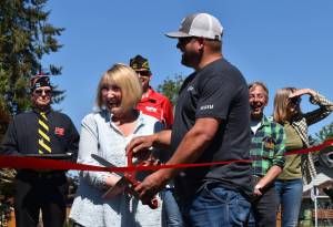 Matthew N. Wells / The Daily World
Linda Springer and Jeff Nations, Cosmopolis parks superintendent, cut the red ribbon in a ceremony that welcomed about 60 people to Highland Park. The park has gone through a slew of renovations, including countless hours from community volunteers.