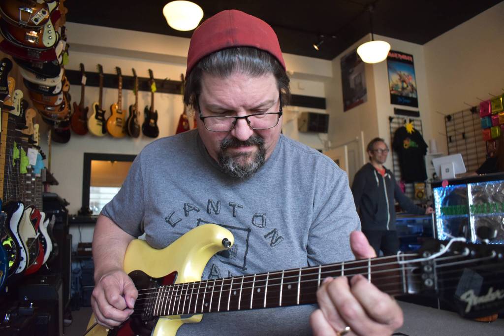 Matthew N. Wells / The Daily World
Don Stone, one of the last part-owners of the former Rosevears Music Center, in downtown Aberdeen, plays an informal game called Stump the Musician. Stone was able to play a few songs exceptionally well as they were all identified with ease. When Stone showed up to Guitar Galactica Wednesday morning, Wil Russoul, director for Downtown Aberdeen Association, greeted him with a Were not worthy, praise of Stone, because of how well Stone plays the guitar.