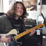 Matthew N. Wells / The Daily World
James Joesten plays an electric guitar with serious flare late Wednesday morning at Guitar Galactica. The 20-year-old guitarist, who played some serious licks, from Pink Floyds Wish You Were Here to Nirvanas Come As You Are and Metallicas Blackened, made his first music purchase  Nirvanas In Utero, album. Joesten bought his first instrument, a clarinet, at the former Rosevears Music Center in downtown Aberdeen.