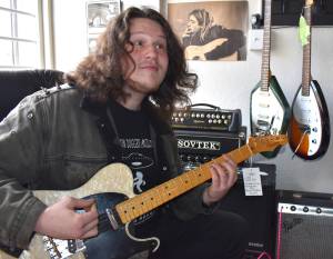 Matthew N. Wells / The Daily World
James Joesten plays an electric guitar with serious flare late Wednesday morning at Guitar Galactica. The 20-year-old guitarist, who played some serious licks, from Pink Floyds Wish You Were Here to Nirvanas Come As You Are and Metallicas Blackened, made his first music purchase  Nirvanas In Utero, album. Joesten bought his first instrument, a clarinet, at the former Rosevears Music Center in downtown Aberdeen.