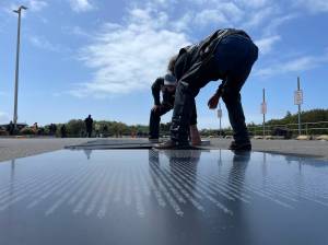 Michael S. Lockett / The Daily World
Volunteers help place a panel of a traveling replica of the Vietnam Veterans Memorial hosted at the Quinault Beach Resort and Casino on June 14.