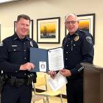 Matthew N. Wells / The Daily World
Aberdeen Police Detective Sgt. Gary Sexton, left, receives a commendation during Aberdeen City Councils meeting on Wednesday night from Hoquiam Police Chief Joe Strong for his actions that helped save two little girls who were kidnapped from the 2700 block of Pacific Avenue, in Hoquiam. A combined effort of social media awareness and quick multi-agency response from Aberdeen, Hoquiam and Cosmopolis, plus Sextons foot pursuit of the suspect, lead to a quick conclusion to the urgent situation, which ended in South Aberdeen.
