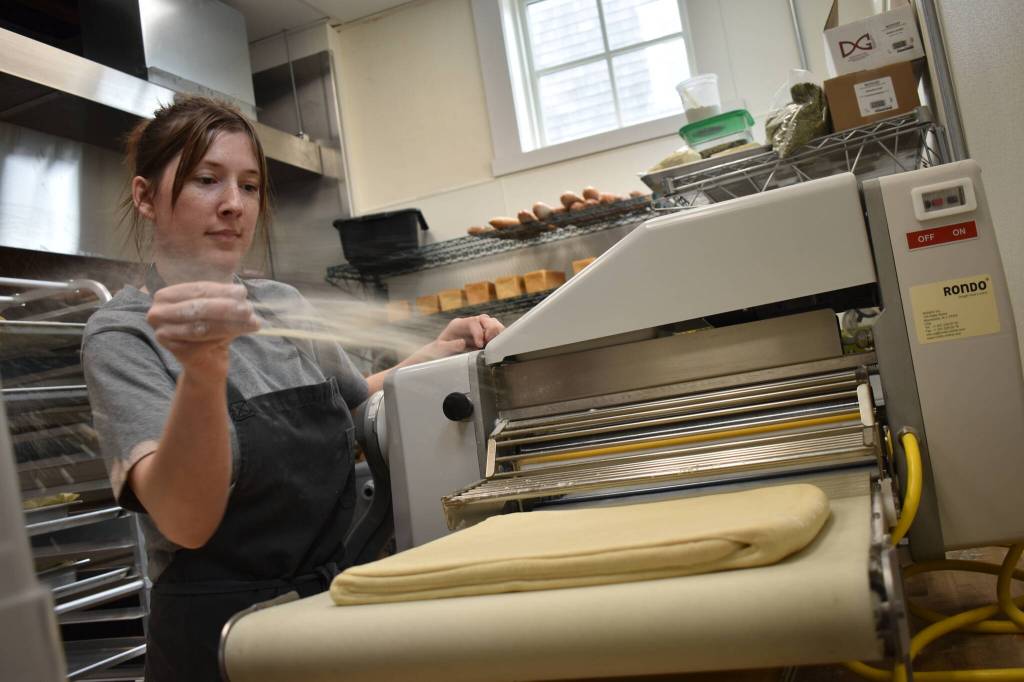 Grace Bryan prepares pastries at the Vista Bakeshop in Seabrook on Friday, June 16. The bakery recently expanded, adding a walk-up window and a dining and working area. (Clayton Franke / The Daily World)
