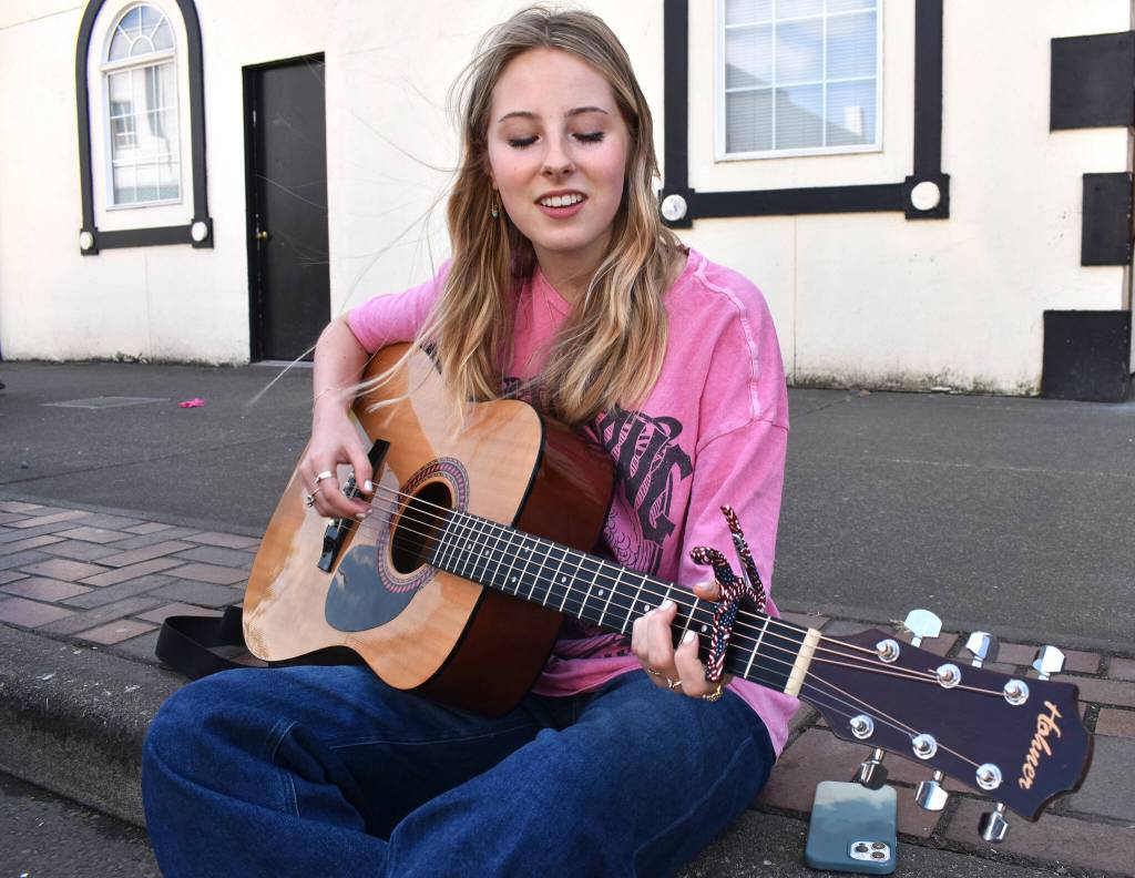 Matthew N. Wells / The Daily World
Belle Tatum, a sweet-sounding singer who traveled from Nashville, plays Teenage Dirtbag, from Wheatus, on Wednesday to celebrate World Music Day. Tatum, originally from Hoquiam, taught herself to play guitar during the quarantine days of the COVID-19 pandemic, but shes been singing since she was 6.