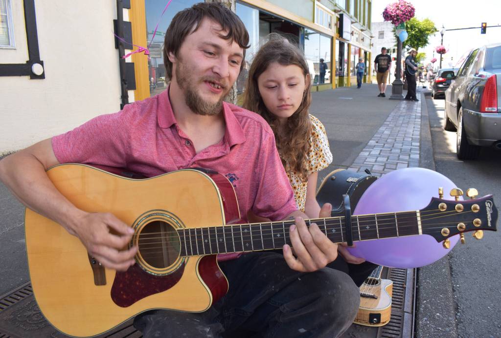 Matthew N. Wells / The Daily World
Benjamin Benjie Sergent plays the acoustic-electric Silvertone guitar he purchased from a locally famous dude, named Warren Mason. Mason, as Sergent tells it, taught Kurt Cobain how to play the guitar. Sergent told the guitars story as his daughter Serenity sits and listens.