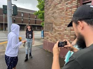 Matthew N. Wells / The Daily World
On Tuesday, Aria Taylor, left, stands with Mia Moore Marchant at the corner of South I and East Market streets in downtown Aberdeen. Taylor will play Tessa in Marchants film Again Again. Laffrey Witbrod, cinematographer for the sci-fi romance indie flick, uses an iPhone to see the shot composition. Co-director Heather Ballish looks at the shot composition. Witbrod said in film you dont just measure twice and cut once, you probably measure seven or eight times and cut once.