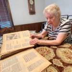 Pat Englund looks clippings of Daily World articles from the 70s, which tell the story of the early days of PAWS of Grays Harbor, now celebrating its 50th anniversary since incorporation. (Michael S. Lockett / The Daily World)